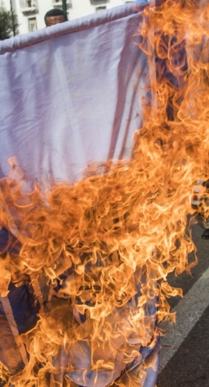 Illustrative: Moroccans burn the Israeli flag during a demonstration against the US Middle East peace plan in the capital Rabat on February 9, 2020. (FADEL SENNA / AFP)